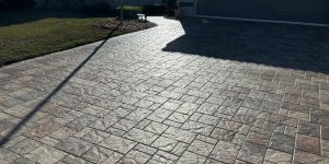 Contractor restoring a paver driveway