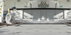 Water sealer beading on a sealed concrete surface