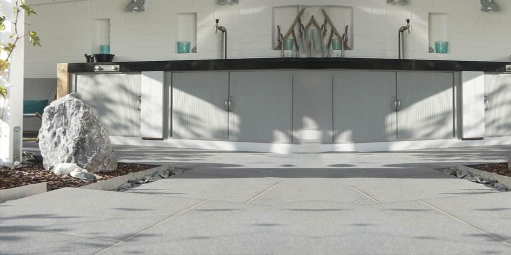 Water sealer beading on a sealed concrete surface