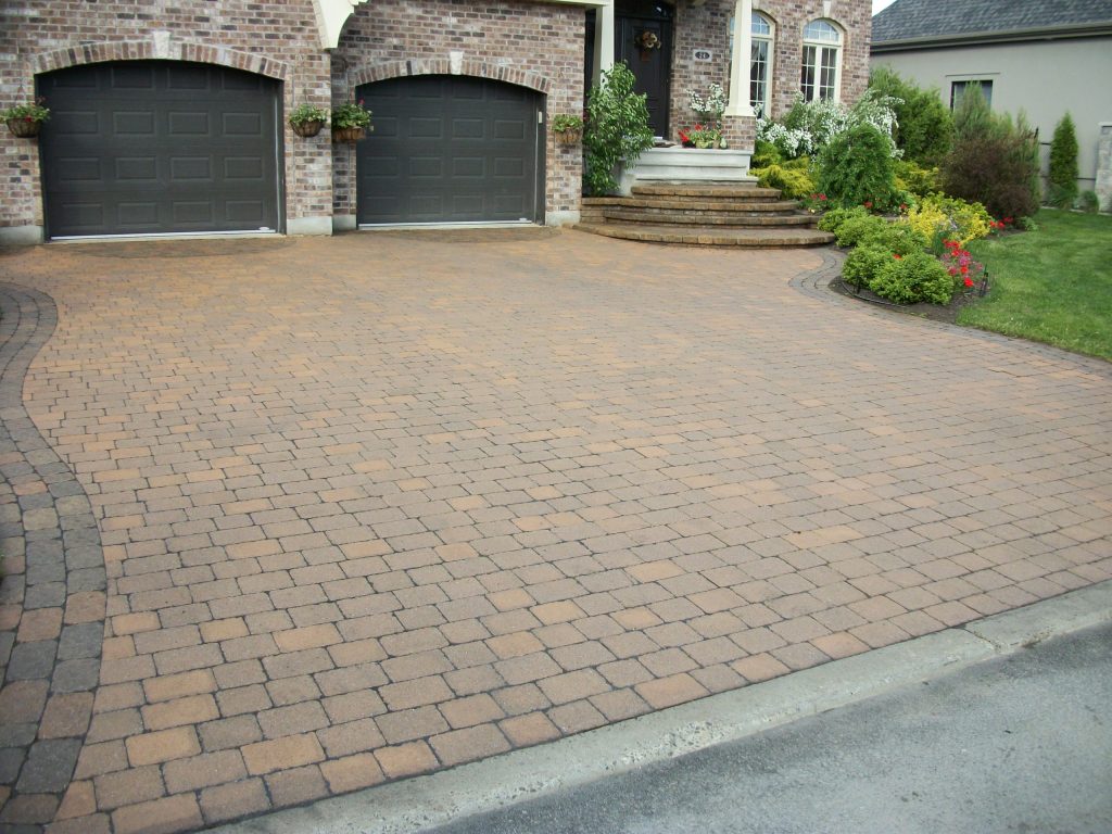 The same driveway after cleaning and sealing, colour even and the darker border reading again