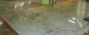 Glossy poured floor coating reflecting the windows of an empty room