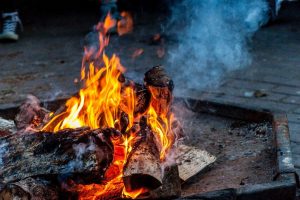 Logs burning in an outdoor fire pit
