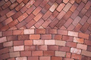 Red and brown brick pavers laid in a running bond