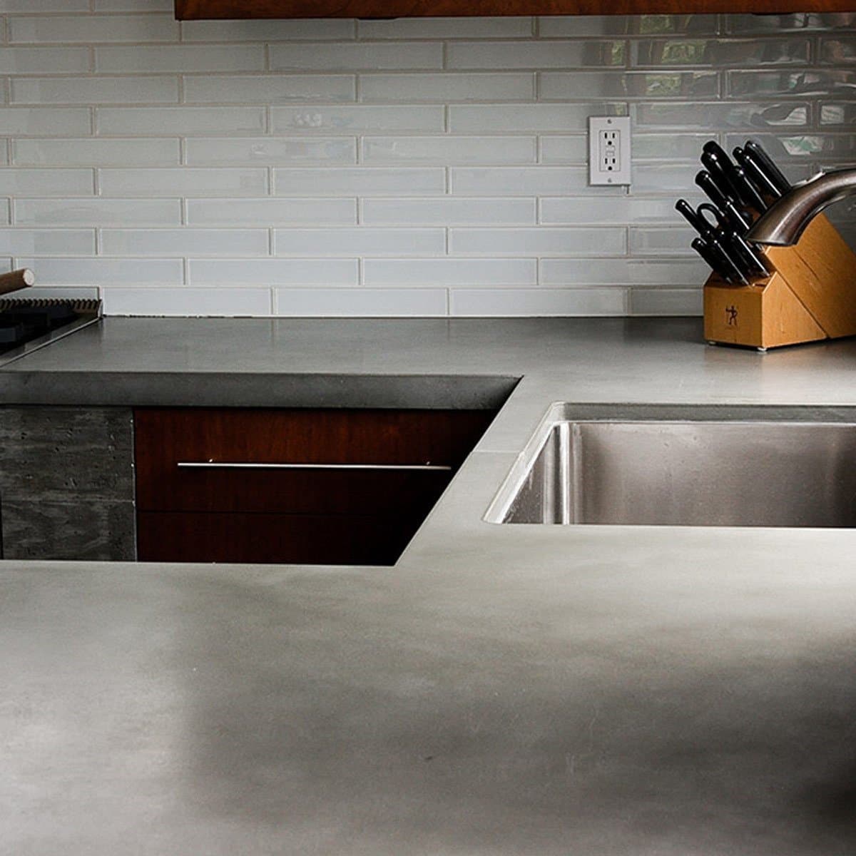 Modern kitchen with a polished concrete countertop and stainless steel sink