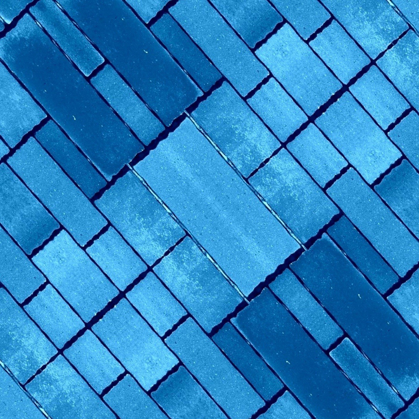 Blue-toned brick paving laid on the diagonal
