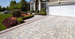 Paver driveway leading to the double garage of a suburban house