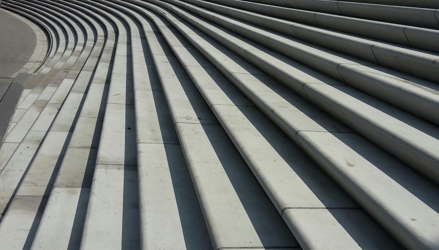 Rows of dark ridged concrete steps receding into the distance