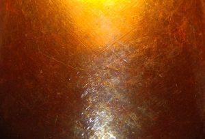 Close-up of amber stained concrete catching the light