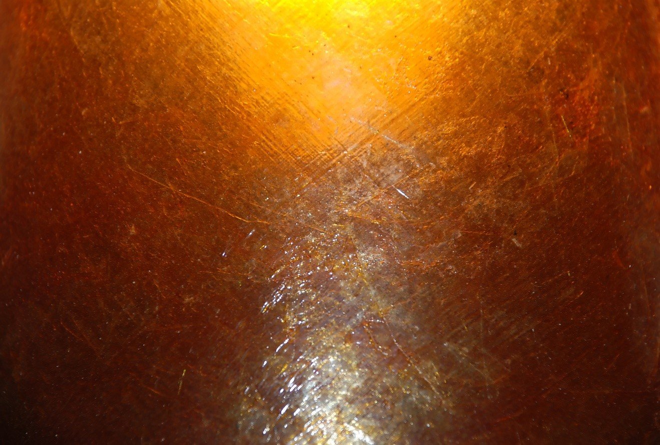 Close-up of amber stained concrete catching the light