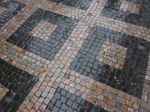 Cobblestone paving laid in a decorative diamond and square mosaic
