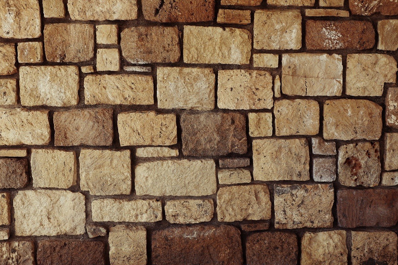 Close-up of tan stacked stone veneer walling