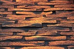 Close-up of warm orange stacked stone cladding