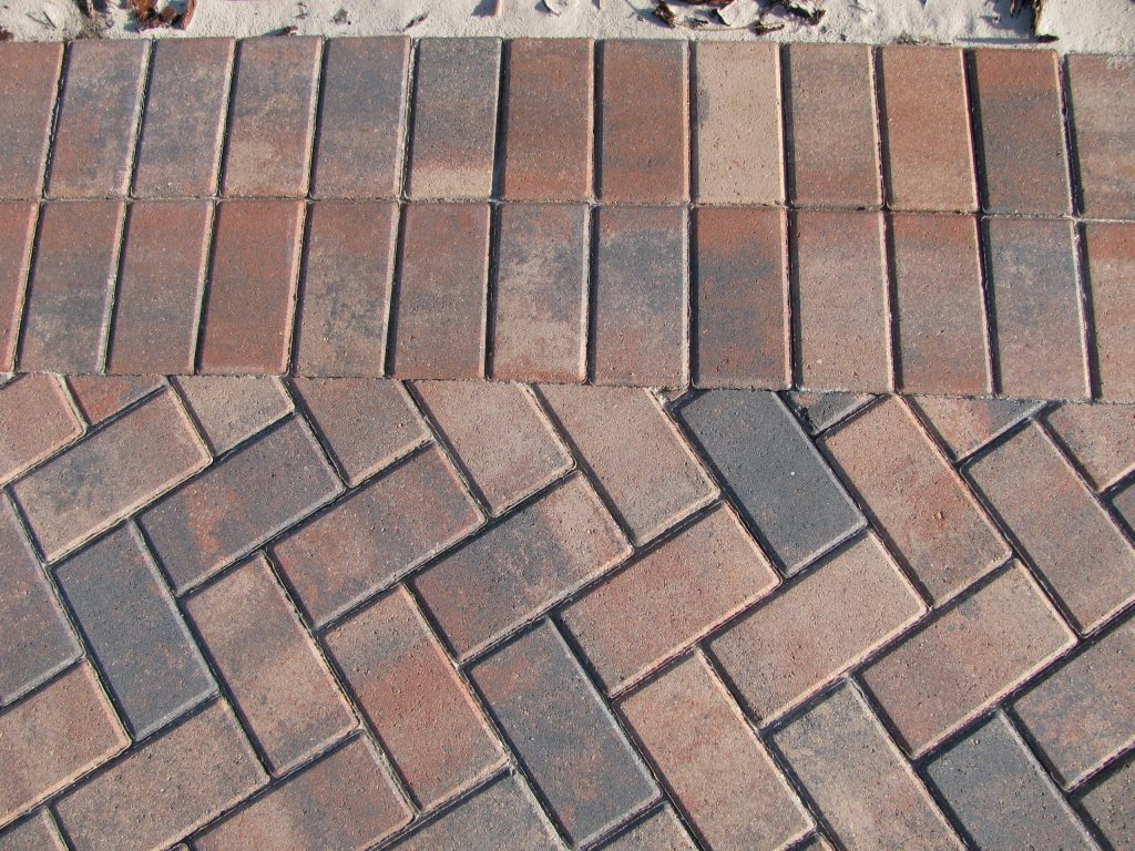 The same walkway after sealing, deep red with the border defined