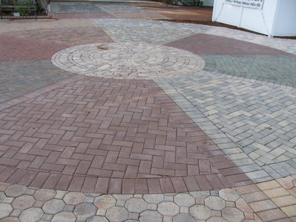 Circular paver medallion in a courtyard, colours muted